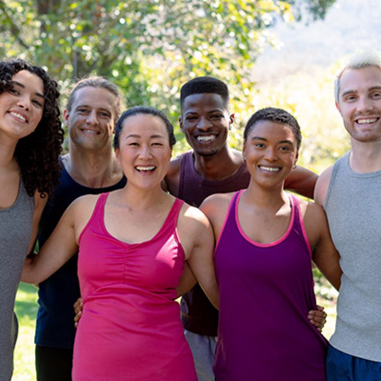Group of happy fit diverse female and male friends holding yoga mats and taking selfie. fitness and healthy, active lifestyle.